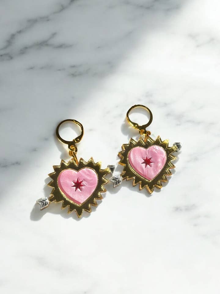 Pink Sacred Heart Earrings – Gold-Plated Huggie Hoops with Arrow Detail for wholesale by Squishy Jewellery