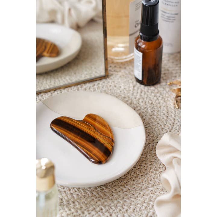 Xander Kostroma - Wholesale Gua Sha tool - Tigers Eye Crystal Gua Sha with Black Skull Pouch