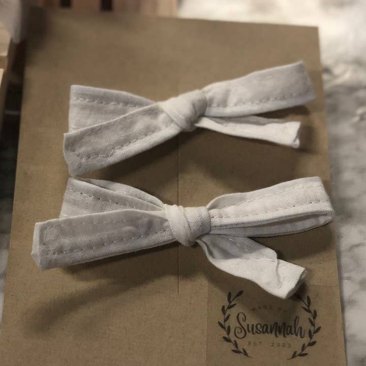 White Mini Hand Tied Piggy Bows for wholesale by MadeBySusannah