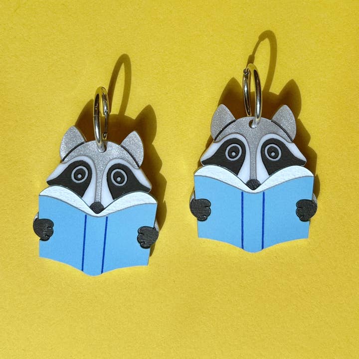 Reading raccoon earrings (handmade) for wholesale by Future Frenzy