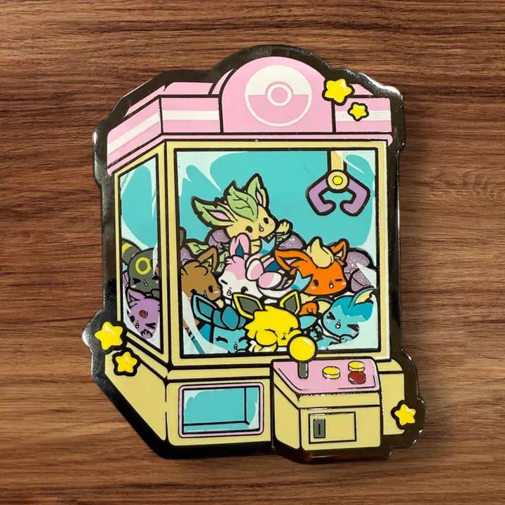 Eeveelutions Claw Machine 3.5" Hard Enamel Pin for wholesale by GoopyGoblins