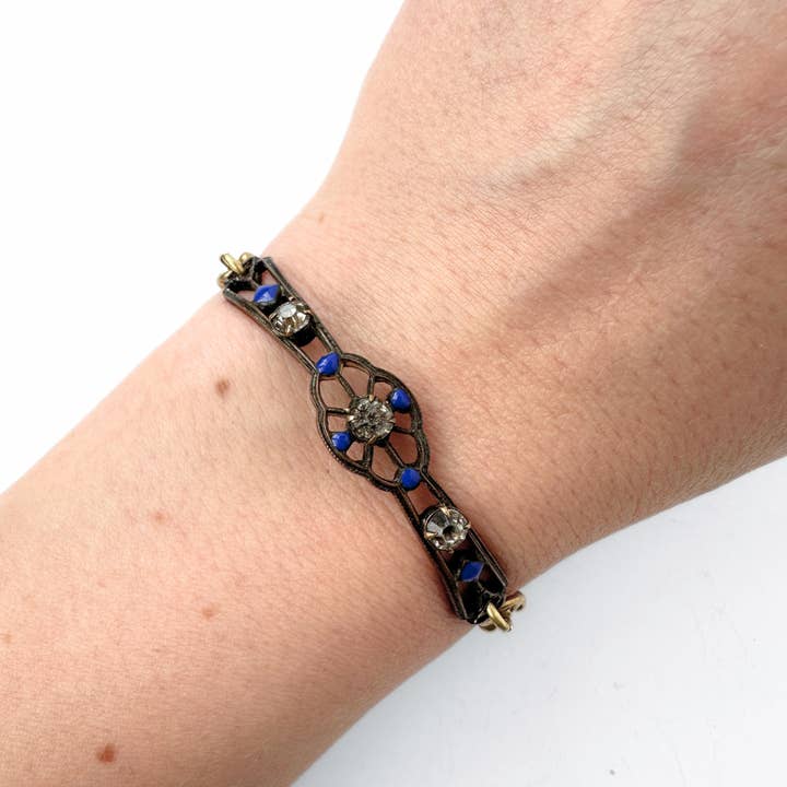 Repurposed antique bronze, blue enamel, and clear rhinestone thin ornate bar bracelet for wholesale by Lulu’s Petals