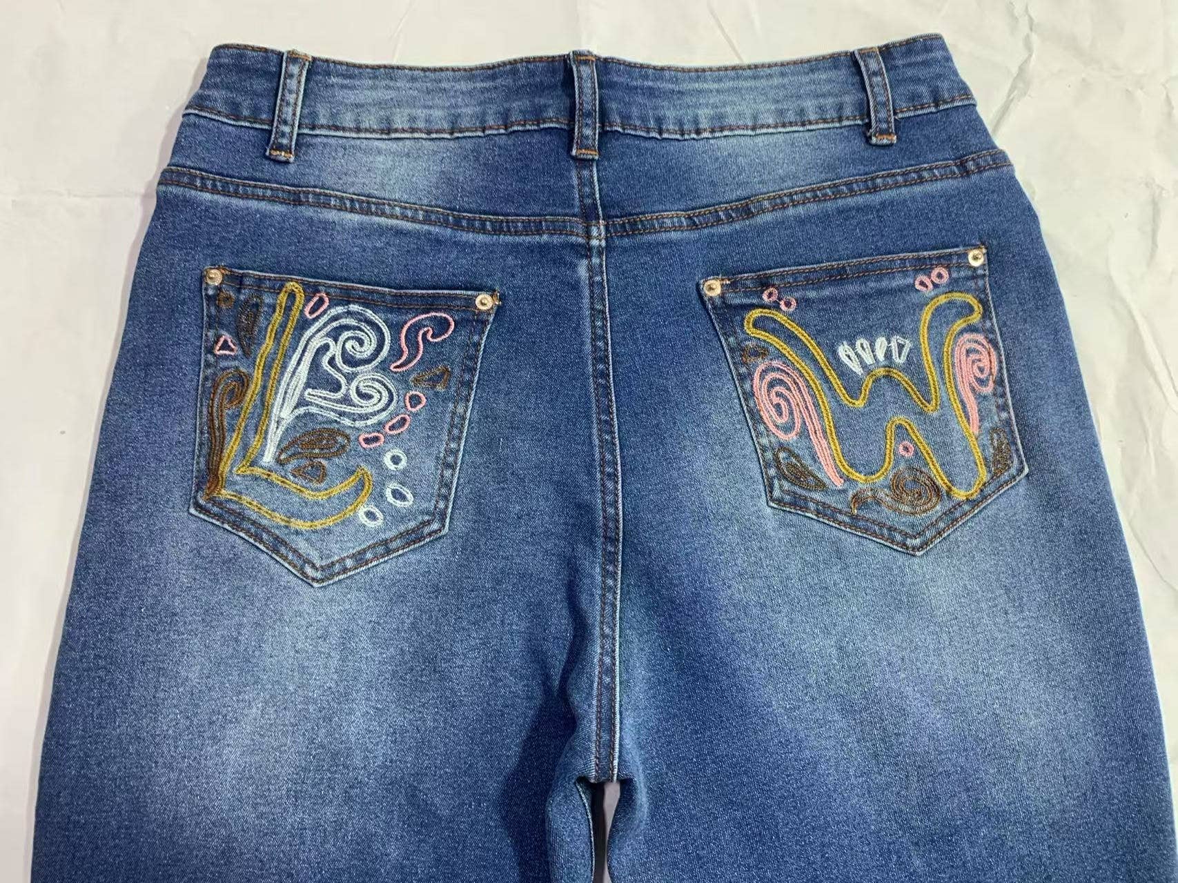 Blue Wild Western Floral Vine Embroidered flare jeans for wholesale on Faire6