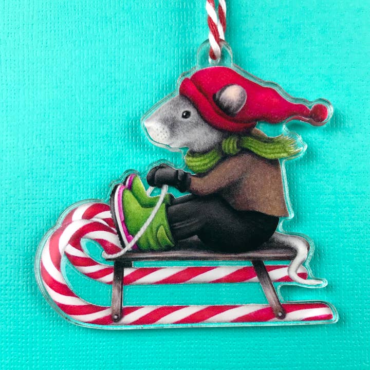 Holiday ornament sledding mouse with striped string for wholesale by Abundance Illustration