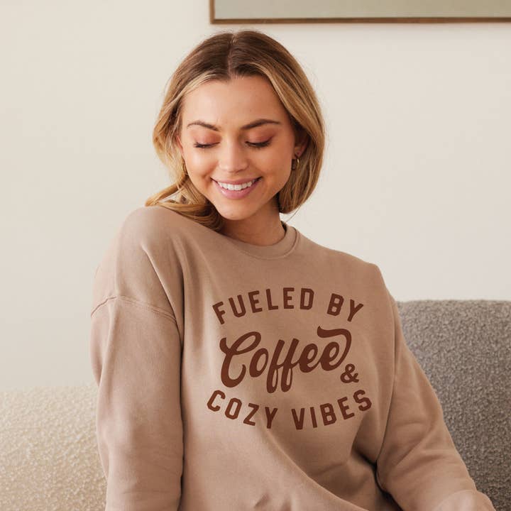 FUELED BY COFFEE AND COZY VIBES Graphic Sweatshirt and other Purchase Wholesale cozy vibes. Free Returns & Net 60 Terms on Faire trending on Faire.