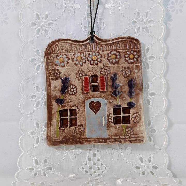 Handmade ceramic house ornament with blue daisies & lavender for wholesale by CurlyFernCeramics