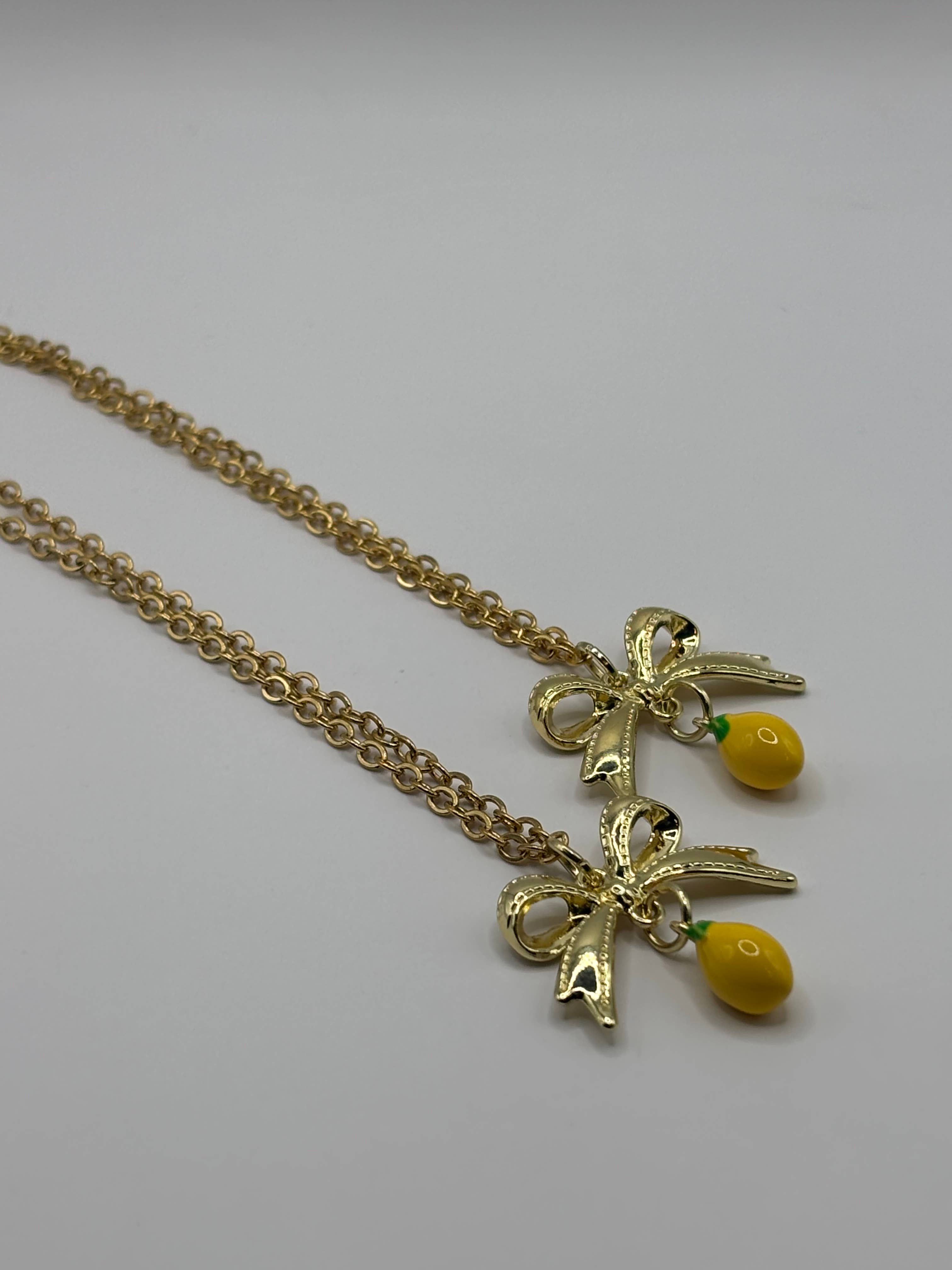 Penny Lane Jewelry Co - Wholesale Pendant/Charm Necklace - Daphne Gold Lemon Bow charm necklace 1