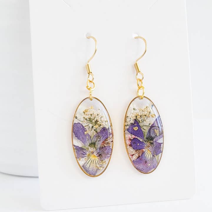 Oval Resin Earrings with Pressed Violets and Gold Dangle for wholesale by NThandmade Jewelry