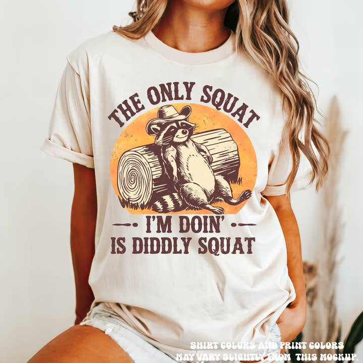 The Only Squat I'm Doing Is Diddley Squat Racoon Tee - Printed On Comfort Colors for wholesale by Madi Moosh