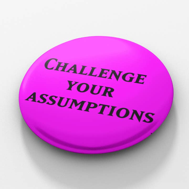 Challenge Your Assumptions 1.5 inch button for wholesale by Cube Monkey Designs