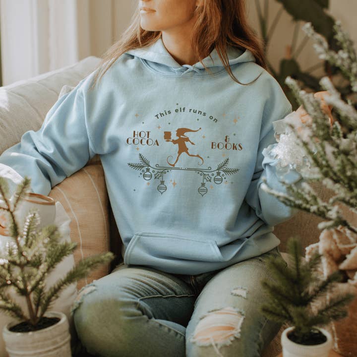 This Elf Runs on Hot Cocoa and Books Hoodie for wholesale by The Bean Workshop