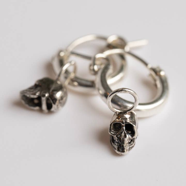 Skull Huggie Hoop Earrings in Sterling Silver for wholesale by Metrix Jewelry