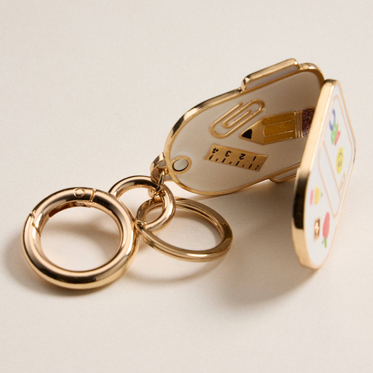 IV Gold Backpack Locket Keychain with School Supply Icons for wholesale on Faire1