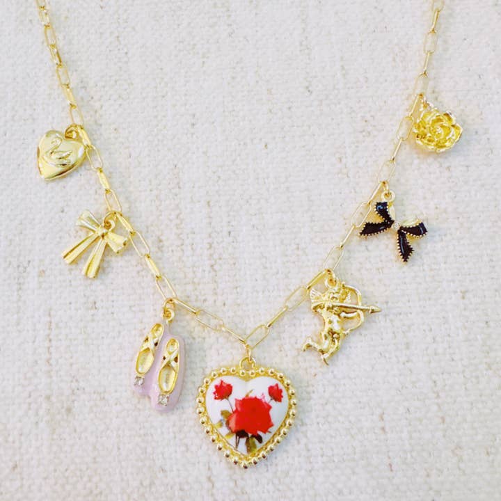 Ballet Garden Charm Necklace – Whimsical Gold Chain with Rose, Swan, Angel & Ballet Shoe Charms for wholesale by Ellison+Young