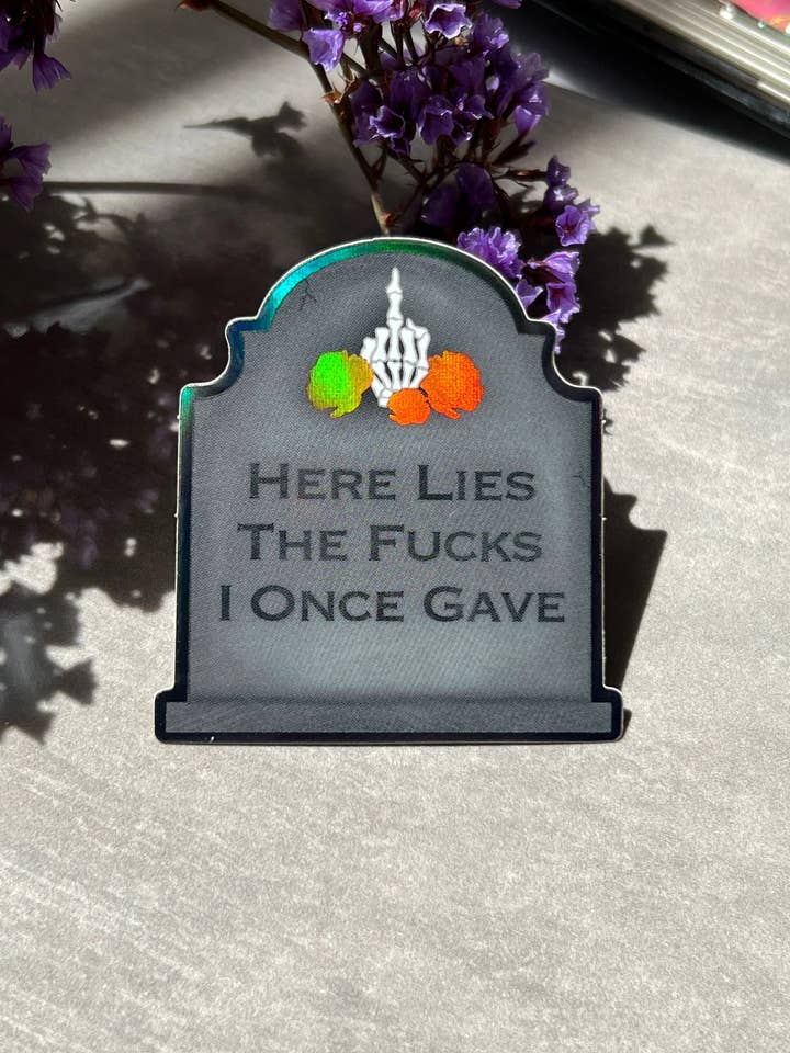 Here Lies The Fucks Holographic Sticker for wholesale by Arch Michael