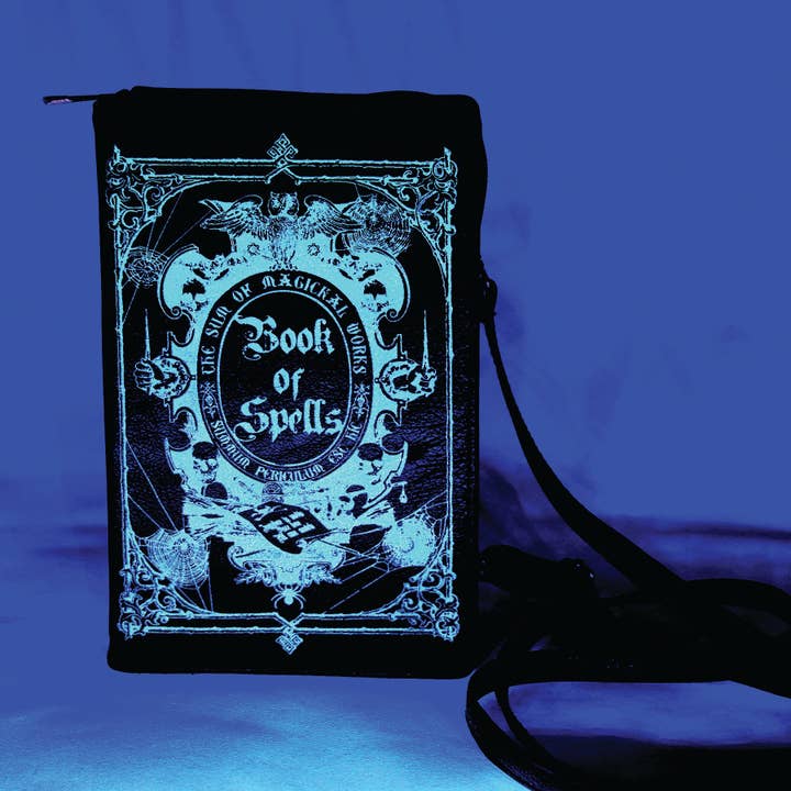 Glow in the Dark Book of Spells Crossbody Bag in Vinyl Material for wholesale by COMECO INC