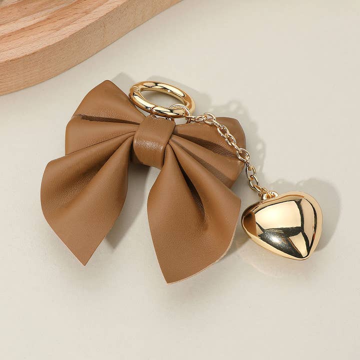 Faux Leather Bow Metal Heart Drop Keychain / Bag Charm and other Purchase Wholesale bow keychain. Free Returns & Net 60 Terms on Faire trending on Faire.