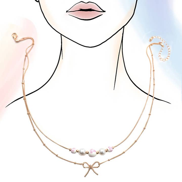 Gold PINK CERAMIC PORCELAIN PEARL BOW LAYER NECKLACE | 80N91556 for wholesale on Faire2
