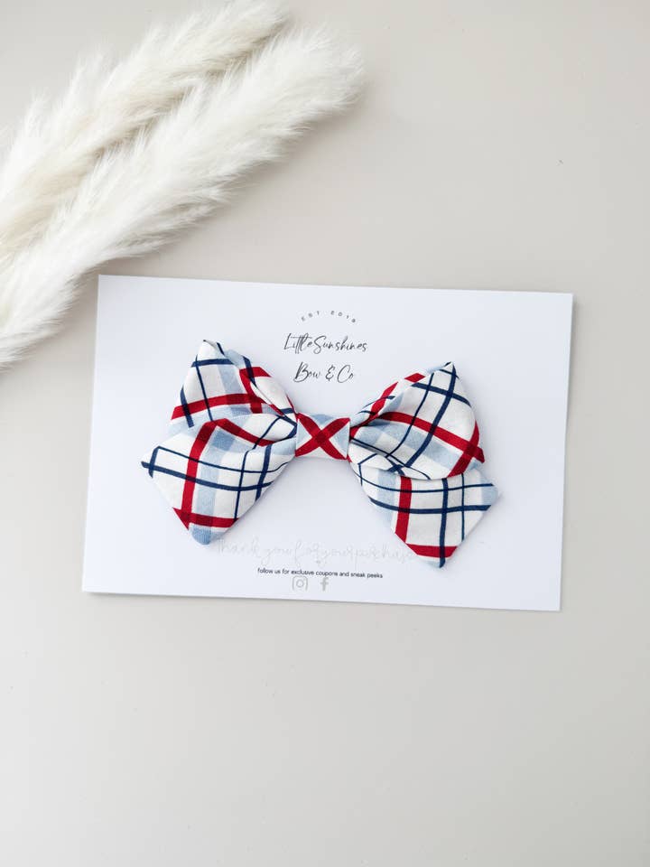 Red White & Blue Plaid 4th of July Pinwheel Hair Bow for wholesale by Little Sunshines Bow & Co