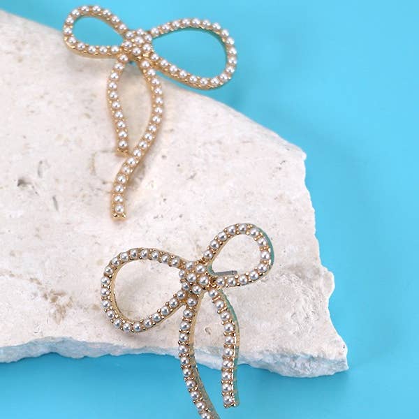 Gold BIG BOW PEARL STUD EARRINGS | 31E24163 for wholesale on Faire