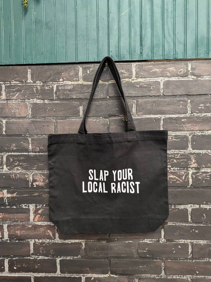 Slap your local racist, Tote Bag for wholesale by Three Black Cats Inc.