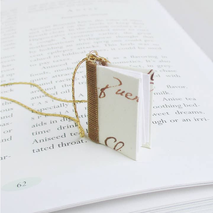 Italian Writings Book Pendant- gold for wholesale by Nicolette Tallmadge Designs