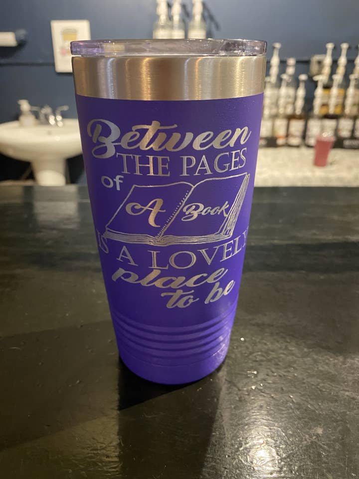 Between the pages - purple laser engraved 20oz thermos for wholesale by Dye and Burn Studios