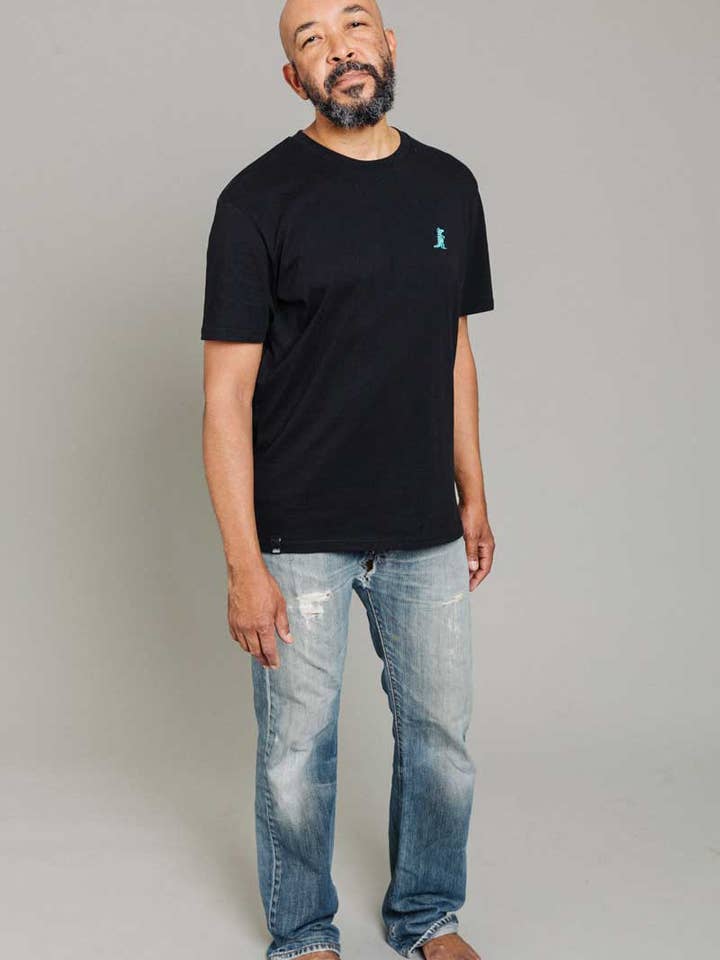 T-shirt unisexe DUMMY dinosaure noir pour la vente par KREUZUEBER