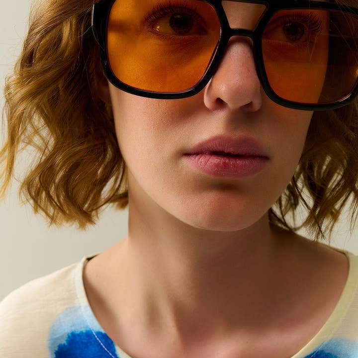 Sunglasses with black frames and orange lenses for wholesale on Faire3