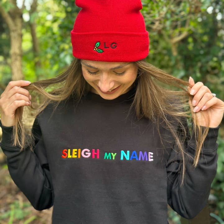 Sleigh My Name Embroidered Christmas Sweatshirt in Black for wholesale by Percy and Nell Retail Limited