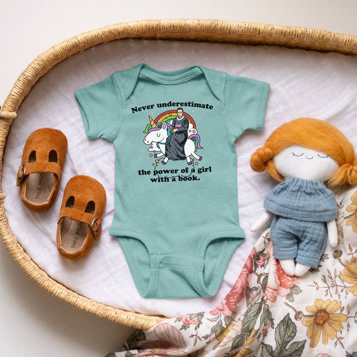 RGB Riding a Unicorn Book Quote Nerdy Baby Onesie© for wholesale by Keen Bee Studio