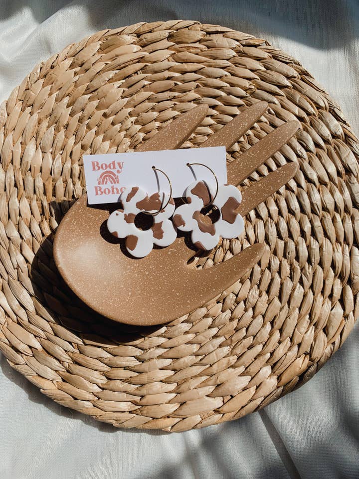 The Cow Print Flower Hoops / Polymer Clay Earrings for wholesale by Body & Boho