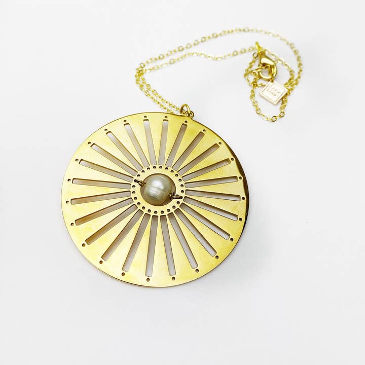 Sunworshipper Gold Disc Pendant with Pearl and other Purchase Wholesale boerewors. Free Returns & Net 60 Terms on Faire trending on Faire.