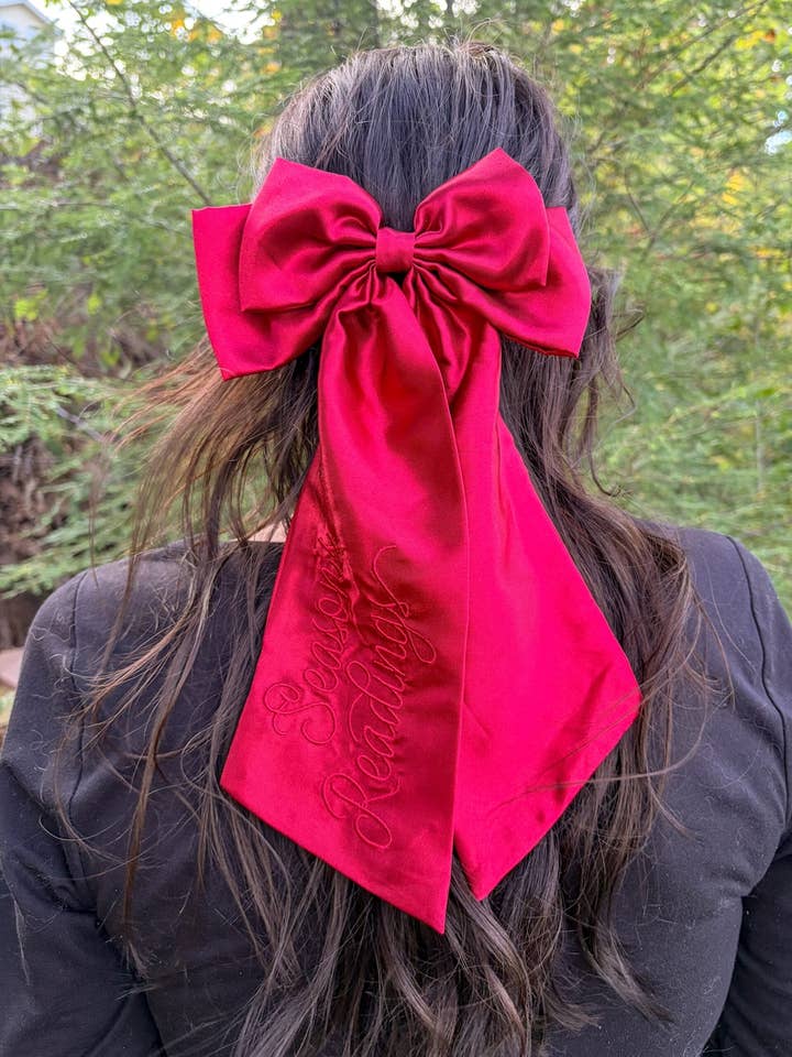 Season's Readings Hair Bow Clip | Bookish Holiday Satin Bow for wholesale by Blissfully Bookish Company