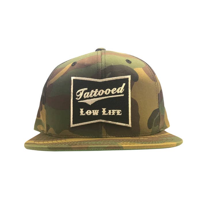Tattooed Low Life Snap Back Hat Green Camo for wholesale on Faire