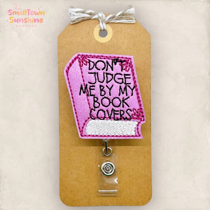 Don't Judge Me by My Book Covers Badge Reel for wholesale by The SmallTownSunshine Company