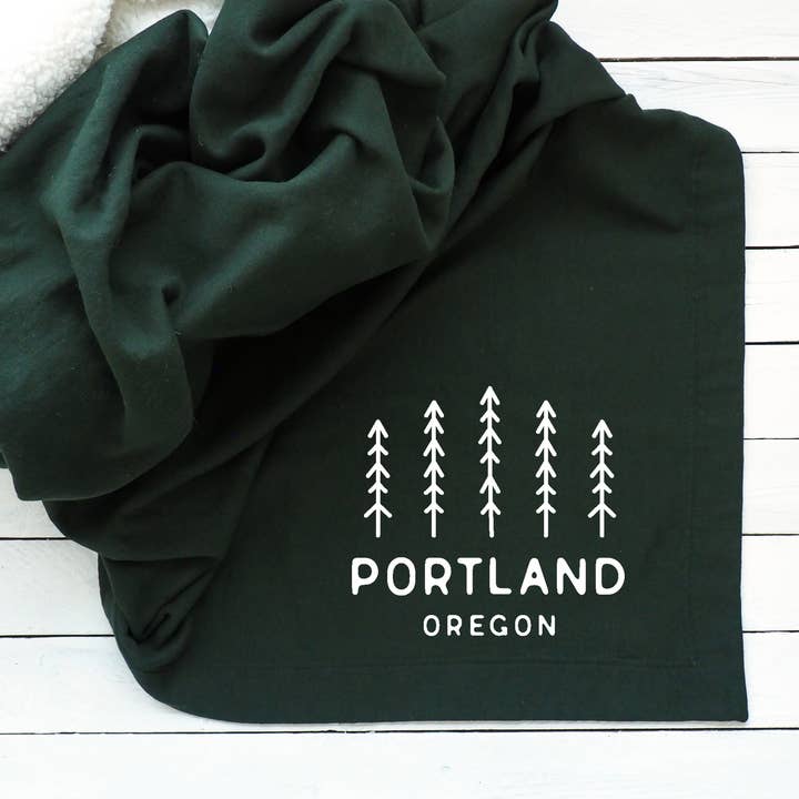 Custom City & State Sweatshirt Throw Blanket With Pine Trees for wholesale by Perfect Day Print Co