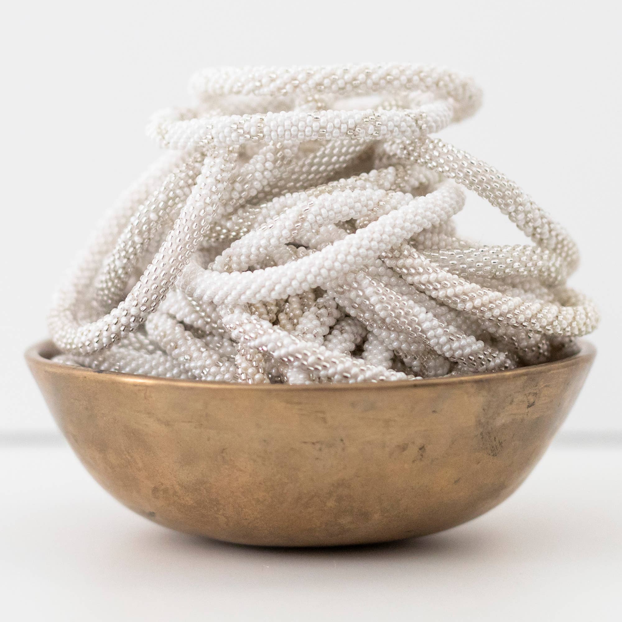 Aid Through Trade - Wholesale Jewelry Set - Roll-On® Bracelets Pearl - Set of 121