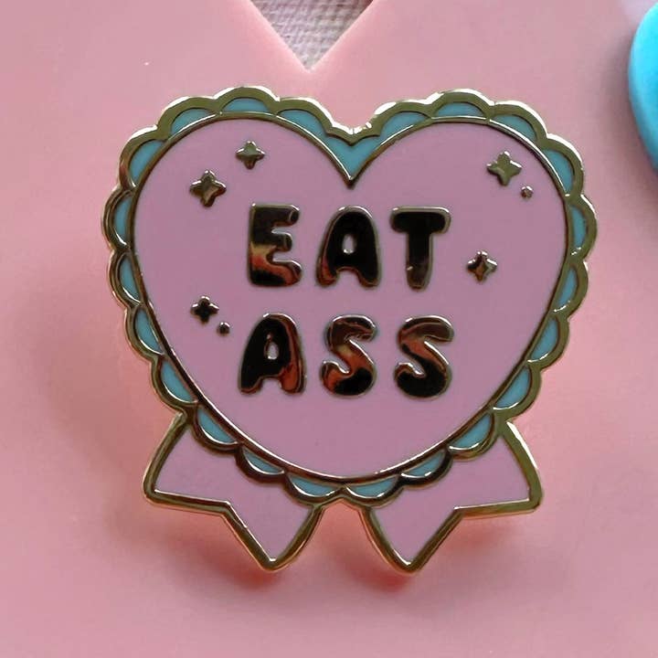 Eat Ass Hard Enamel Pin for wholesale by Loveli Atelier