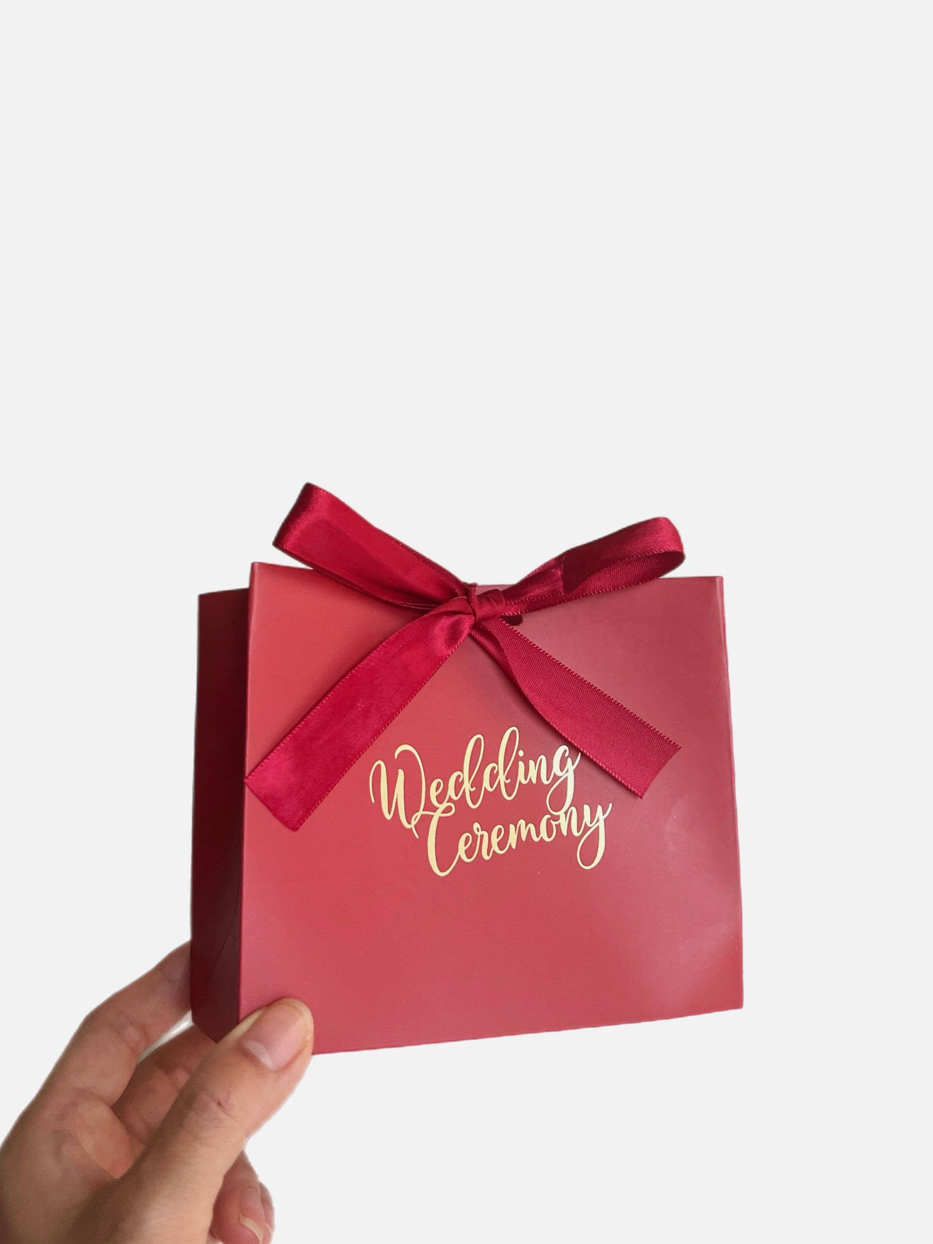 Rosso Borsa regalo rossa in carta con nastro per bomboniere e regali festivi in vendita all'ingrosso su Faire1