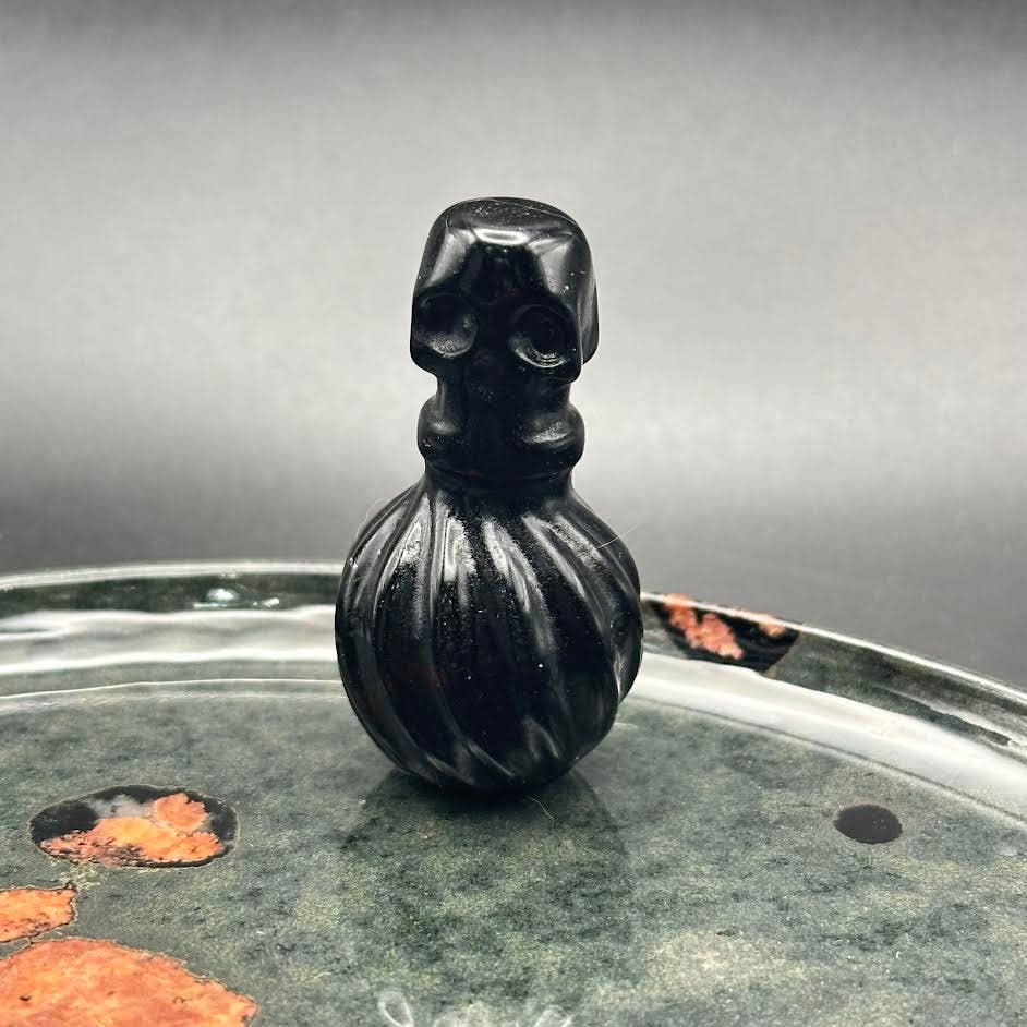 The Crystal Tabby - Wholesale Decorative Tabletop Object - Obsidian Poison Bottle - Round Bottle with Skulls1