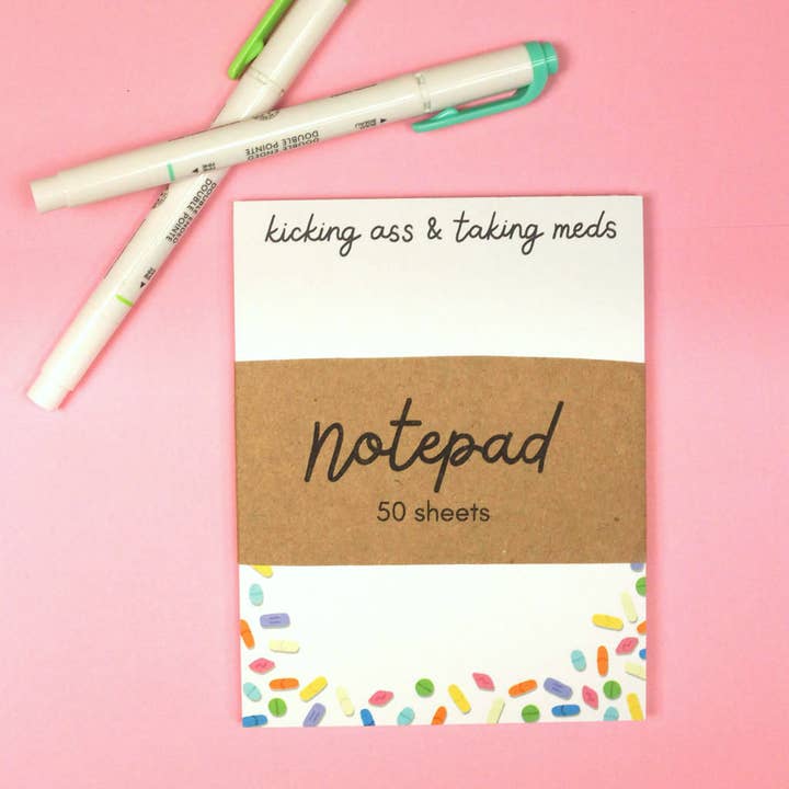 Kicking Ass & Taking Meds Notepad for wholesale by Raspberry Cloud Studio