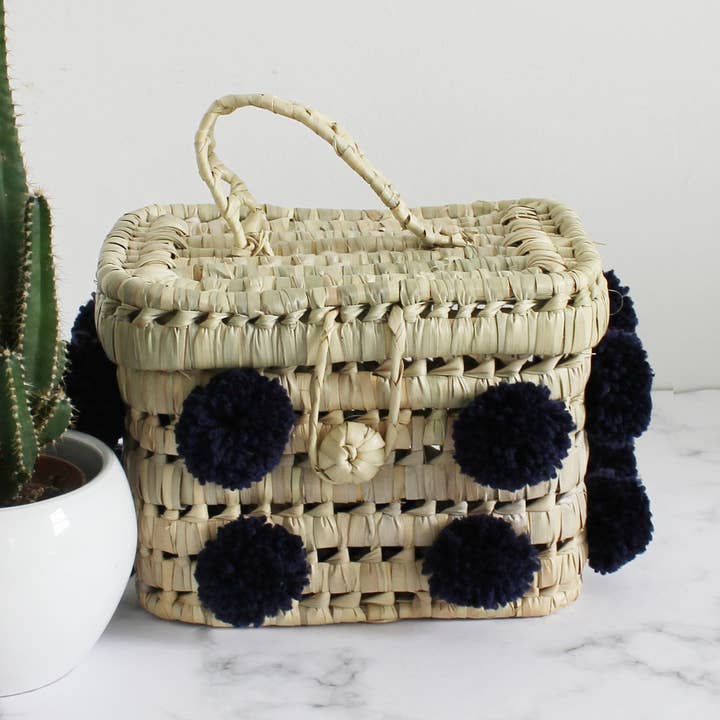 moroccan small navy pompom basket bag for wholesale by MARRAKECH METACRAFT LTD