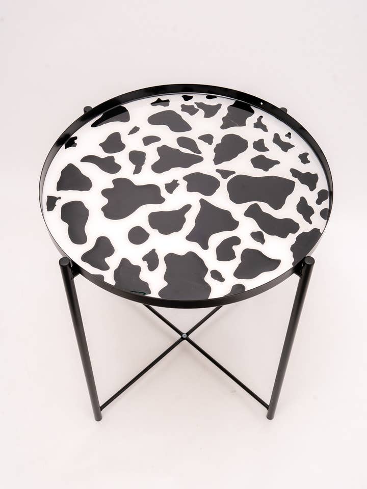 Cow print resin table for wholesale by Paige Alexander