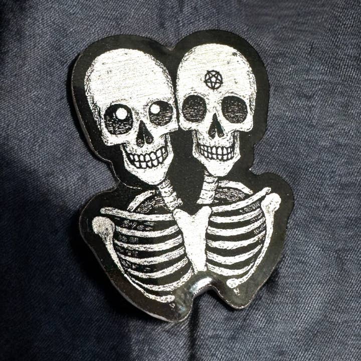 Conjoined Skeletons - Eco Enamel Pin Badge for wholesale by The Enamel Pin Factory