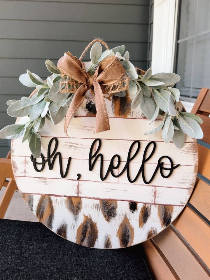 Oh hello, hand painted cow print door hanger for wholesale by MaeLynn’s