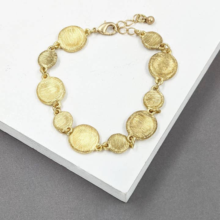 Delicate designer style scratch finish disc bracelet for wholesale by Tempest Designs