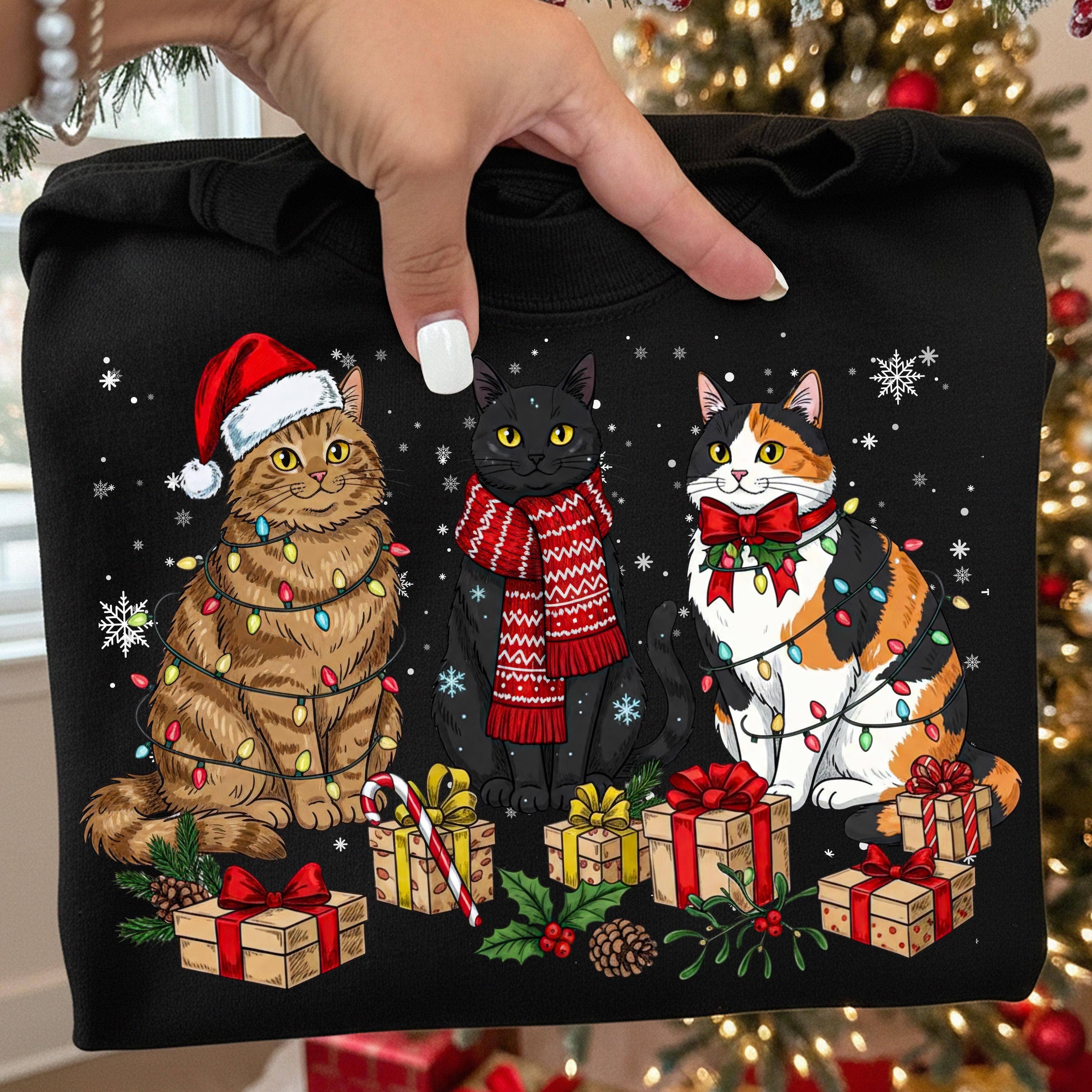 DLT Ecommerce – Großhandel T-Shirt (Grafikdruck) – Damen – Meowy-Christmas-Shirt, Süße Katzen mit Weihnachtsmannmütze Pullover1