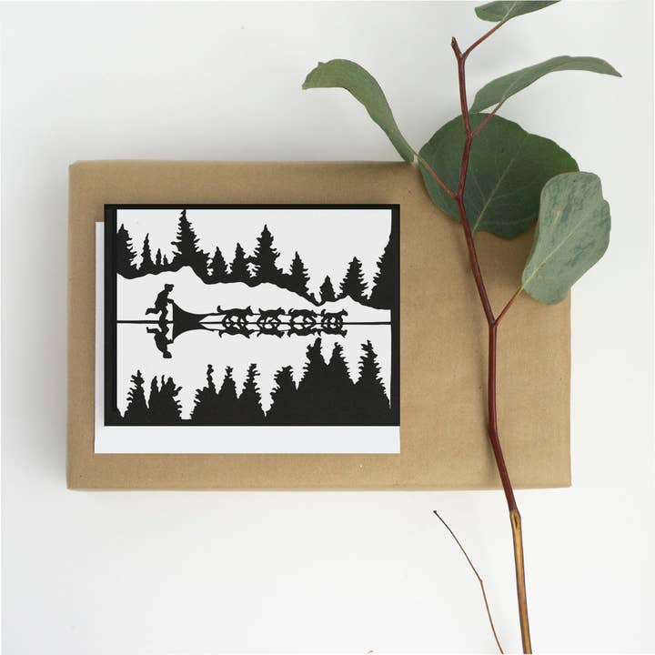 Greeting Card - Snow Dogs huskies across the ice for wholesale by Squirrel Tacos Papercuts