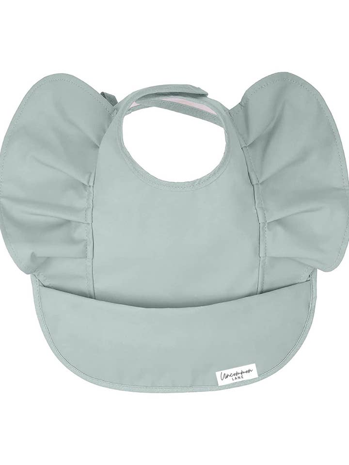 Wing Ruffle Waterproof Bib in Sage for wholesale by Uncommon Lane